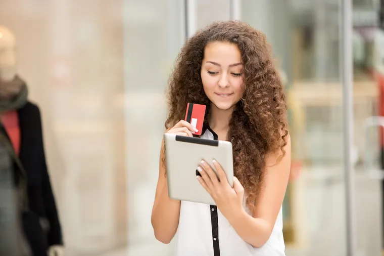 A girl paying by credit card for shopping